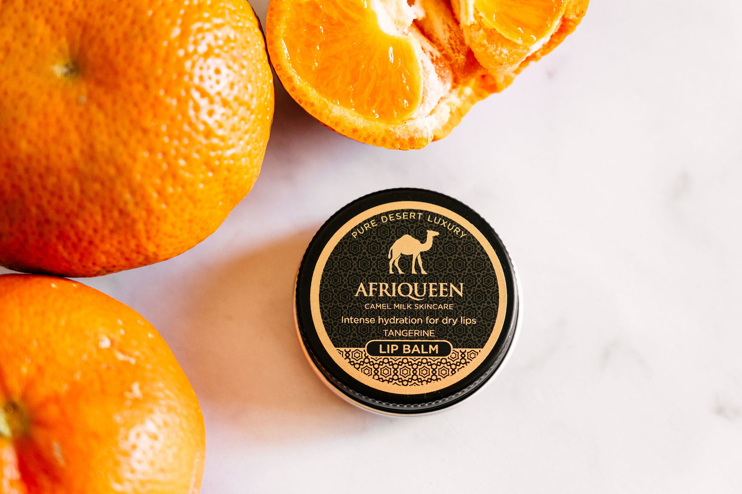 Lip balm container with oranges on a white background