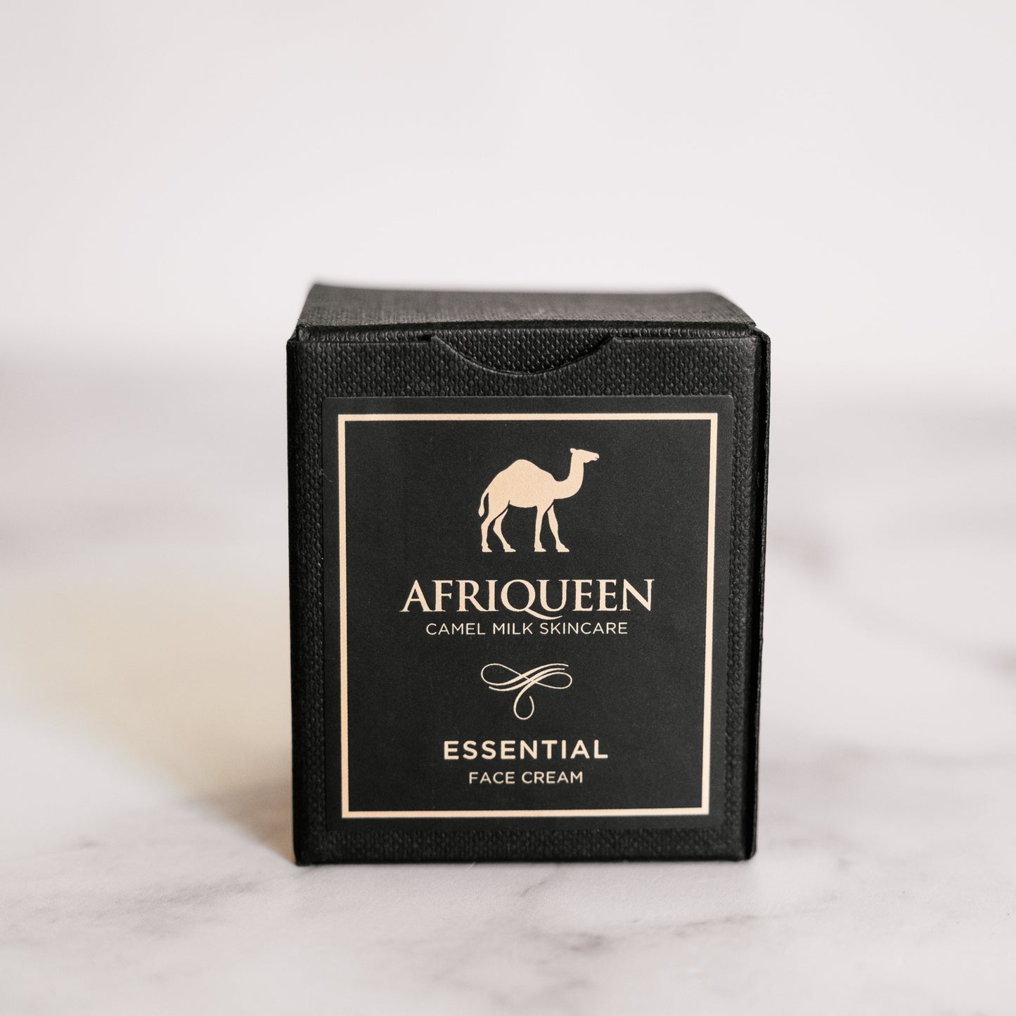 Black box of Afriqueen Essential Face Cream on a light gray background