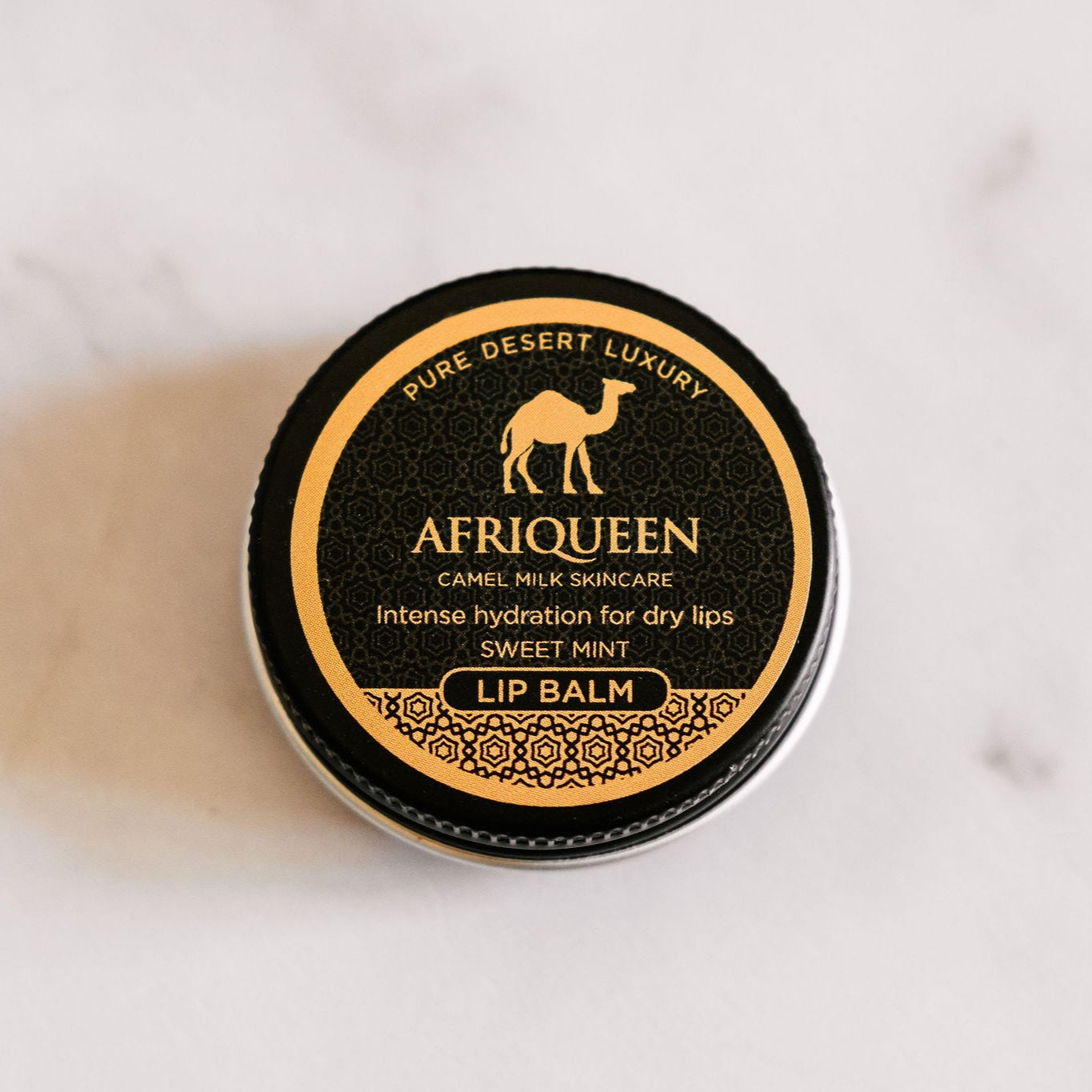 Afriqueen lip balm container on a white background