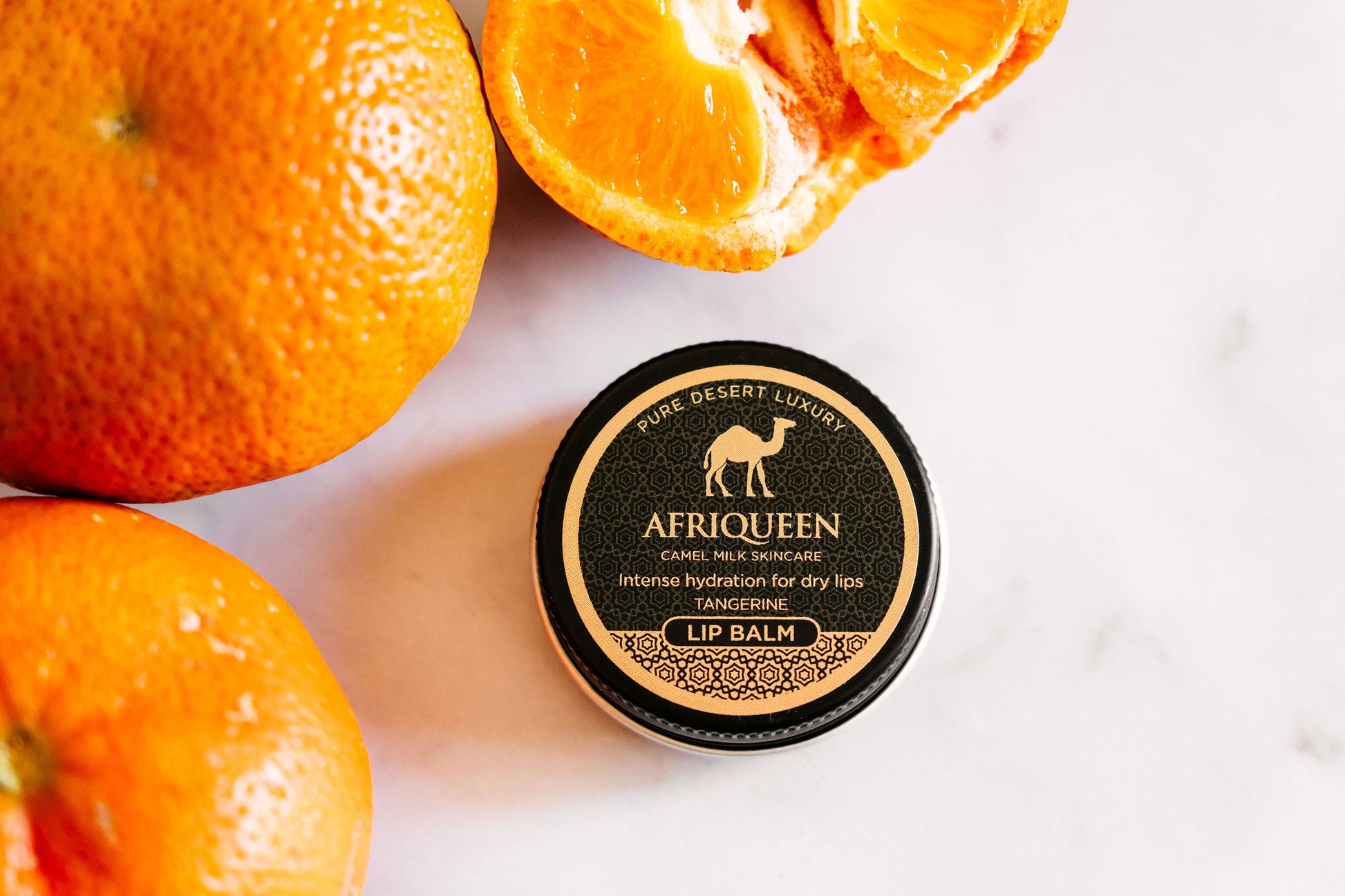 Lip balm container with oranges on a white background